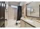 Bathroom featuring tiled shower and tub, vanity with granite countertop, and framed mirror at 14885 Caravan Ave, Odessa, FL 33556