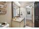 Bathroom features a granite countertop, rustic mirror, and decor, creating a cozy and stylish space at 14885 Caravan Ave, Odessa, FL 33556