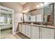 Bathroom with double sink vanity and granite countertops at 14885 Caravan Ave, Odessa, FL 33556