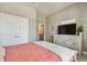A well-lit bedroom offers ample storage with a large closet, complemented by a cozy carpet and soft textures at 14885 Caravan Ave, Odessa, FL 33556