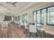 Clubhouse seating area with tables, chairs, bar seating, plank floors, and large windows at 14885 Caravan Ave, Odessa, FL 33556