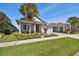 Beautiful single-Gathering home with manicured lawn, colorful landscaping, and a two-car garage at 14885 Caravan Ave, Odessa, FL 33556