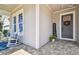 Welcoming front porch featuring a rocking chair, 'Welcome' sign, and lovely flower pot at 14885 Caravan Ave, Odessa, FL 33556