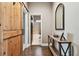 Hallway featuring hardwood floors, a sliding barn door, and a view into the bathroom at 14885 Caravan Ave, Odessa, FL 33556