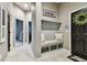 Entryway mudroom area with built-in bench and storage at 14885 Caravan Ave, Odessa, FL 33556
