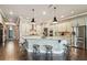 Stunning kitchen with a large island, custom cabinetry, and stainless steel appliances, perfect for entertaining at 14885 Caravan Ave, Odessa, FL 33556