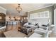 Open floor plan with living, dining, and kitchen areas, featuring hardwood floors and lots of natural light at 14885 Caravan Ave, Odessa, FL 33556