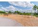 A delightful playground with swings and climbing structures sits on a wood chip base with a beautiful lawn in the background at 14885 Caravan Ave, Odessa, FL 33556
