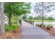 A peaceful pond with a wooden boardwalk surrounded by trees offers a serene escape to nature and community enjoyment at 14885 Caravan Ave, Odessa, FL 33556