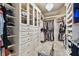 Walk-in closet with custom shelving and a chandelier at 14885 Caravan Ave, Odessa, FL 33556