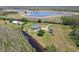 Picturesque property with a home overlooking a tranquil lake, offering serene views and abundant natural beauty at 19530 Barrie Acres Trl, Odessa, FL 33556