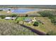 Picturesque property with a home overlooking a tranquil lake, offering serene views and abundant natural beauty at 19530 Barrie Acres Trl, Odessa, FL 33556