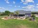 Aerial view of a home with custom pool, surrounded by lush landscaping at 19530 Barrie Acres Trl, Odessa, FL 33556