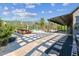 Spacious backyard with paved patio, picnic table, tropical pool, palms, and mature landscaping at 19530 Barrie Acres Trl, Odessa, FL 33556