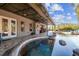 This backyard features a custom pool with spa, covered patio, and lush landscaping at 19530 Barrie Acres Trl, Odessa, FL 33556