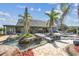 A bridge connects a resort-style lagoon pool with palm trees and an outdoor seating area at 19530 Barrie Acres Trl, Odessa, FL 33556