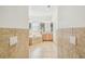 Bright bathroom features tiled floors, soaking tub, double vanity, and ample lighting at 19530 Barrie Acres Trl, Odessa, FL 33556