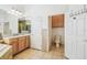 Bright bathroom features a vanity, separate toilet room, and tiled floors at 19530 Barrie Acres Trl, Odessa, FL 33556