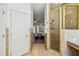 Bathroom showcasing tiled floors, shower, and a glimpse into the main bedroom at 19530 Barrie Acres Trl, Odessa, FL 33556