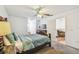 Bright bedroom with a wooden bed frame, TV and doorway to another room at 19530 Barrie Acres Trl, Odessa, FL 33556