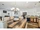 Dining room with decorative chandelier and access to kitchen and bar area at 19530 Barrie Acres Trl, Odessa, FL 33556