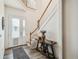 Bright foyer with a decorative glass door, staircase, wood floors and console table at 19530 Barrie Acres Trl, Odessa, FL 33556