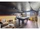 Spacious game room with a pool table, wood floors, and comfortable seating at 19530 Barrie Acres Trl, Odessa, FL 33556