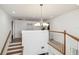 Bright open hallway with wooden floors and white railing and staircase at 19530 Barrie Acres Trl, Odessa, FL 33556