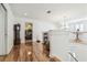 Bright hallway with wood floors and a view into the main bedroom at 19530 Barrie Acres Trl, Odessa, FL 33556