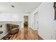 Hallway with wood floors, chair and view into a seating room at 19530 Barrie Acres Trl, Odessa, FL 33556