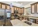 Updated kitchen showcasing stainless steel appliances, granite countertops, and ample cabinet space at 19530 Barrie Acres Trl, Odessa, FL 33556