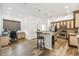 Open-concept kitchen featuring an island with bar seating, stainless steel appliances, and wood flooring at 19530 Barrie Acres Trl, Odessa, FL 33556