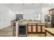 Kitchen island with stainless steel wine fridge, granite counters and view of adjacent breakfast nook and work area at 19530 Barrie Acres Trl, Odessa, FL 33556