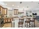 Kitchen featuring a large center island with seating, granite countertops, and stainless steel appliances at 19530 Barrie Acres Trl, Odessa, FL 33556