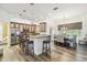 Open kitchen with wood-look flooring, stainless steel appliances and island seating at 19530 Barrie Acres Trl, Odessa, FL 33556