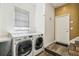Bright laundry room featuring modern LG washer and dryer, with natural light and white walls at 19530 Barrie Acres Trl, Odessa, FL 33556