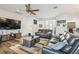 Bright living room with wood-look floors, neutral colors, and comfortable seating at 19530 Barrie Acres Trl, Odessa, FL 33556