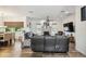 Open-concept living room featuring a fireplace, ceiling fan, and wood-look flooring at 19530 Barrie Acres Trl, Odessa, FL 33556
