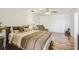 Spacious main bedroom with decorative lamps, wood floors and sitting chair at 19530 Barrie Acres Trl, Odessa, FL 33556