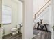 Half bathroom featuring a toilet and staircase at 19530 Barrie Acres Trl, Odessa, FL 33556