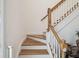Staircase with wood treads, white risers and white railing with wood banister at 19530 Barrie Acres Trl, Odessa, FL 33556
