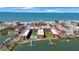 Stunning aerial view of a coastal condo complex with a pool, boat docks, and ocean access at 19701 Gulf Blvd # 231, Indian Shores, FL 33785