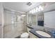 Modern bathroom with glass-enclosed shower, elegant fixtures, and granite countertop at 19701 Gulf Blvd # 231, Indian Shores, FL 33785