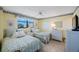 Charming bedroom with twin beds, soft lighting, and a picturesque window view at 19701 Gulf Blvd # 231, Indian Shores, FL 33785