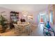 Bright dining area featuring a glass table, charming chandelier, and convenient pass-through to the kitchen at 19701 Gulf Blvd # 231, Indian Shores, FL 33785