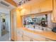 Charming kitchen with white cabinets and a pass-through to the living area and lovely view at 19701 Gulf Blvd # 231, Indian Shores, FL 33785
