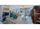 Open living area with water views, tile flooring, comfortable seating, and mirrored wall accents at 19701 Gulf Blvd # 231, Indian Shores, FL 33785
