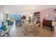 Inviting living room with water views, comfortable seating, chandelier lighting, and a decorative dining area at 19701 Gulf Blvd # 231, Indian Shores, FL 33785