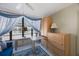 Comfortable living area with a blue couch, bright windows, and built-in storage at 19701 Gulf Blvd # 231, Indian Shores, FL 33785