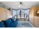 Inviting living room featuring a comfortable blue couch, large windows, and stylish decor at 19701 Gulf Blvd # 231, Indian Shores, FL 33785